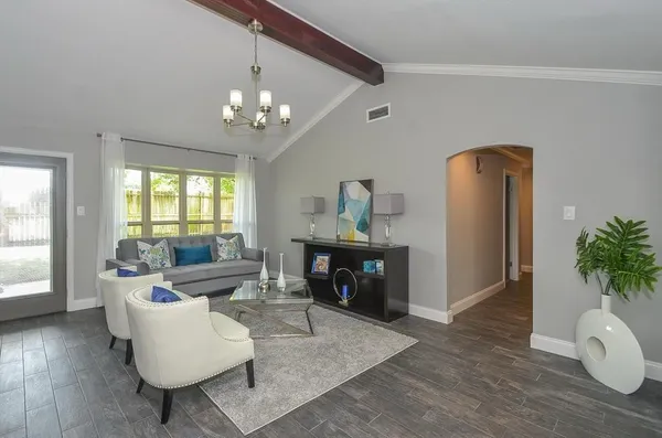 a living room with furniture and a chandelier