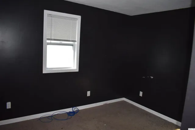 a view of an empty room and a window