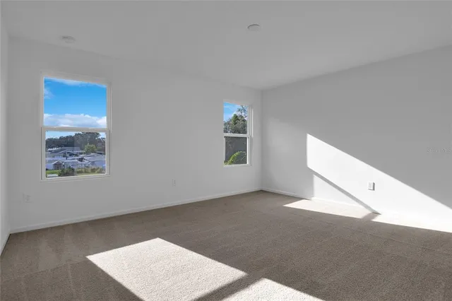 a view of an empty room with windows