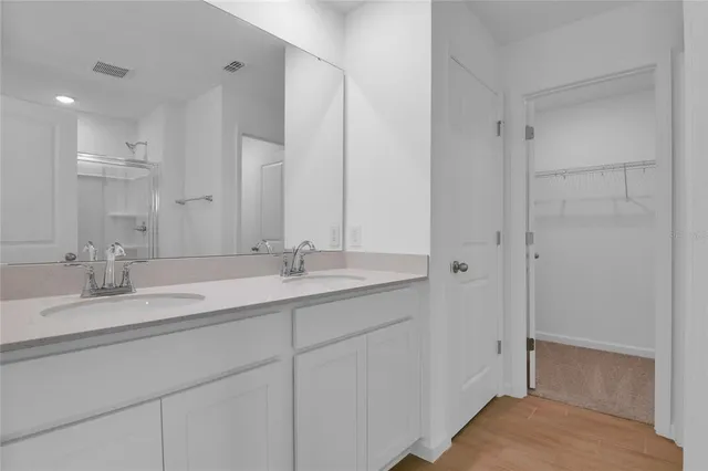 a bathroom with a double vanity sink mirror and double
