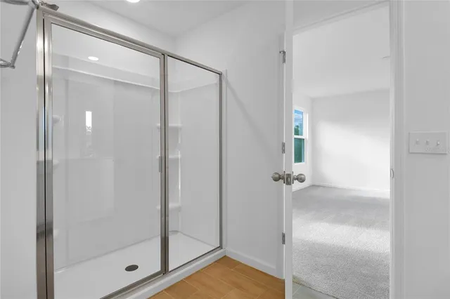 a bathroom with a glass shower door