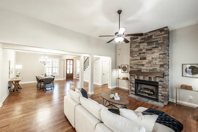 a view of a dining room with furniture large window and wooden floor