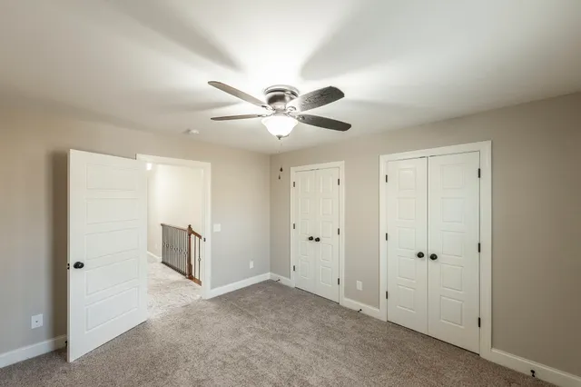 a view of a room with a ceiling fan