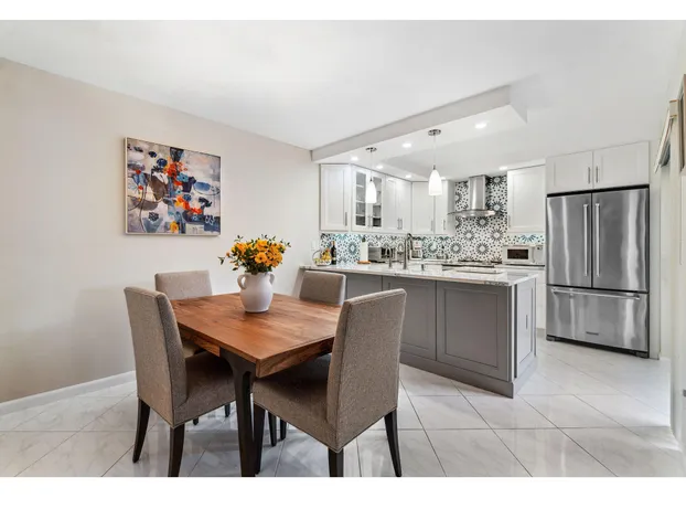 a kitchen with a dining table and chairs