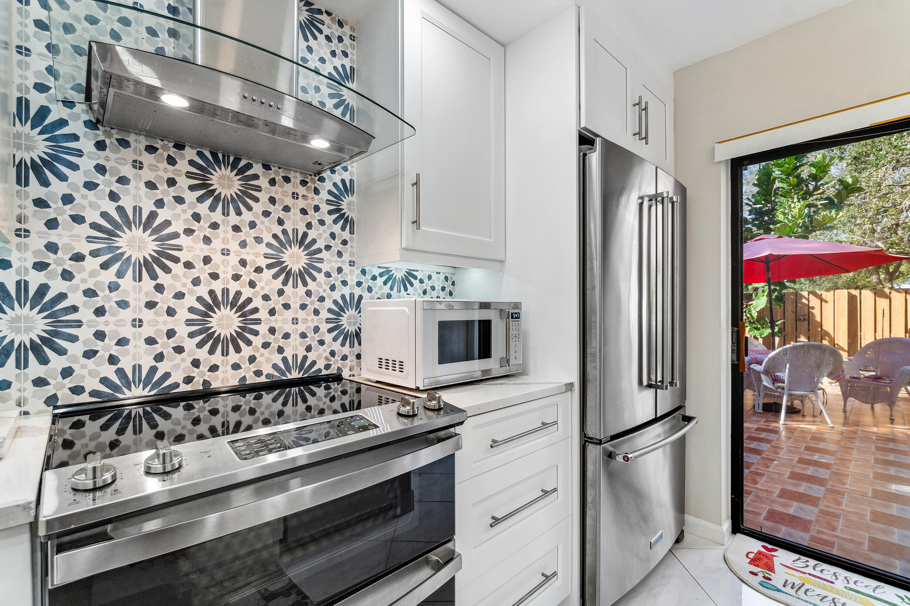 2906 29th Court Jupiter, FL 33477 - Photo 13 of 31 a kitchen with a stove and a refrigerator