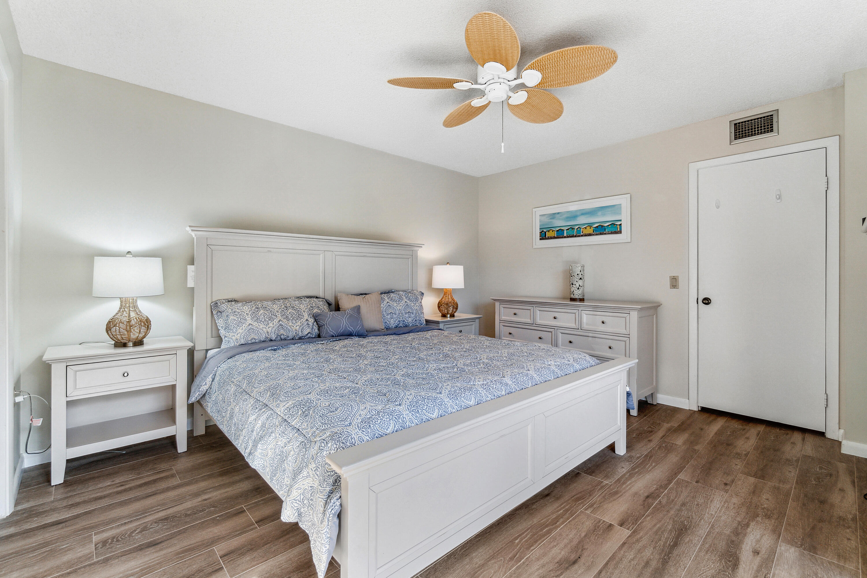 2906 29th Court Jupiter, FL 33477 - Photo 18 of 31 a bedroom with a bed and a chandelier