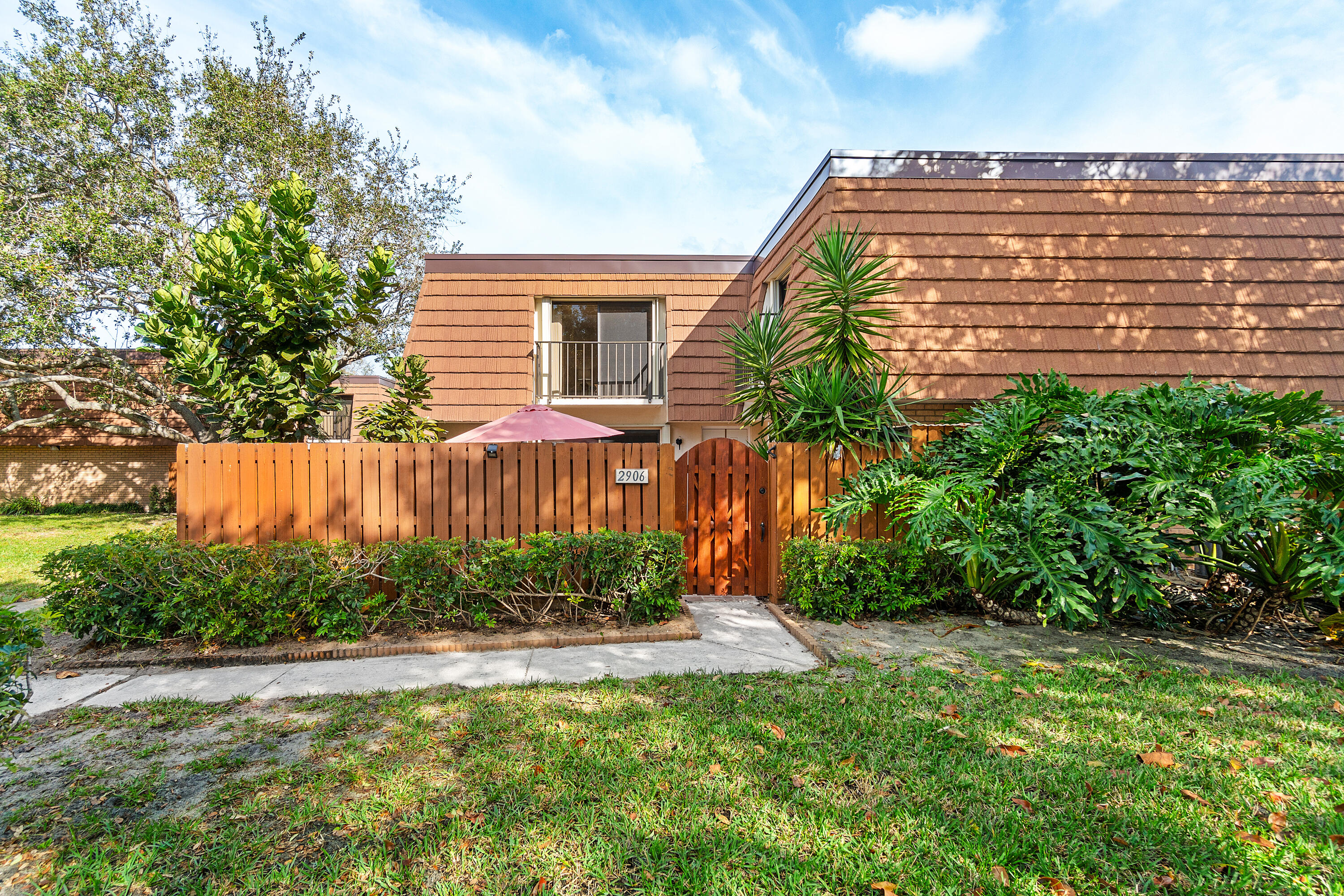 2906 29th Court Jupiter, FL 33477 - Photo 2 of 31 a view of a backyard with plants and a garden