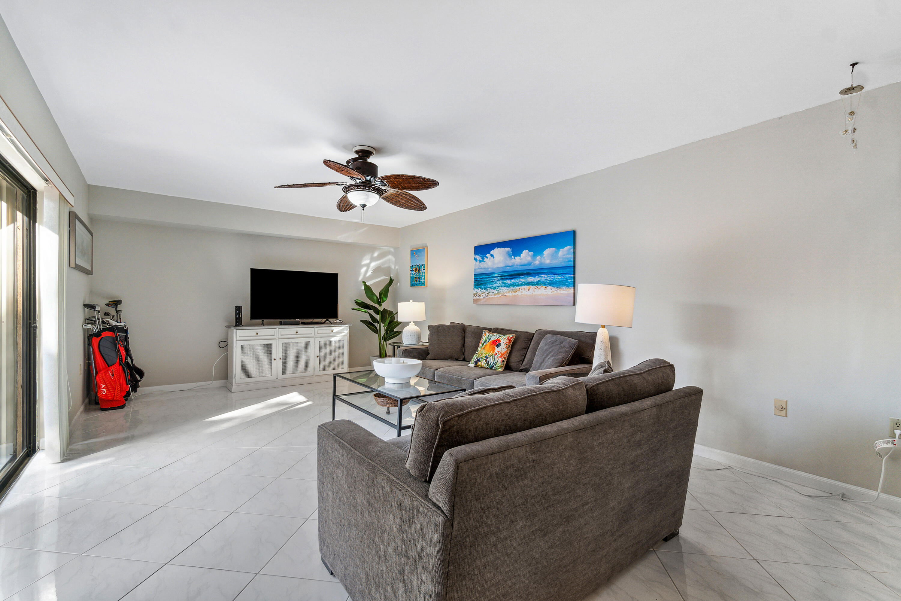 2906 29th Court Jupiter, FL 33477 - Photo 9 of 31 a living room with furniture and a flat screen tv