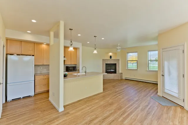 a view of a kitchen cabinets wooden floor and a refrigerator