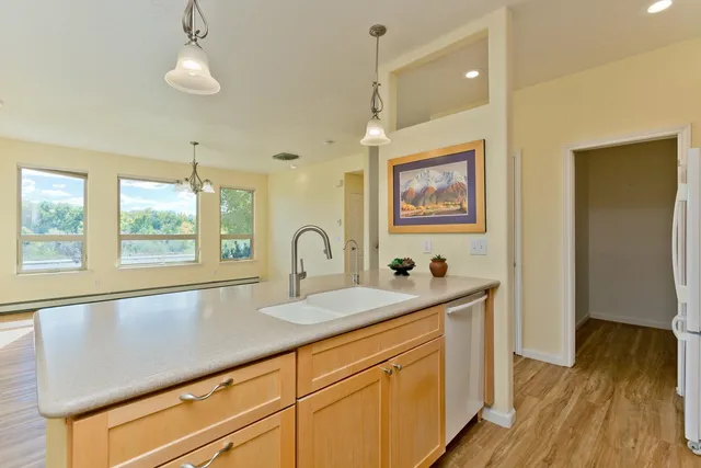 a view of hall way with furniture and wooden floor