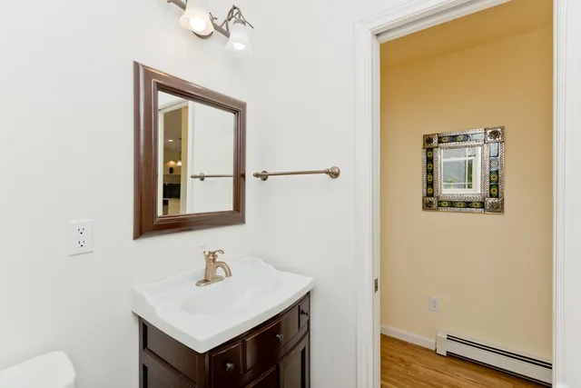 a bathroom with a sink a mirror and a toilet