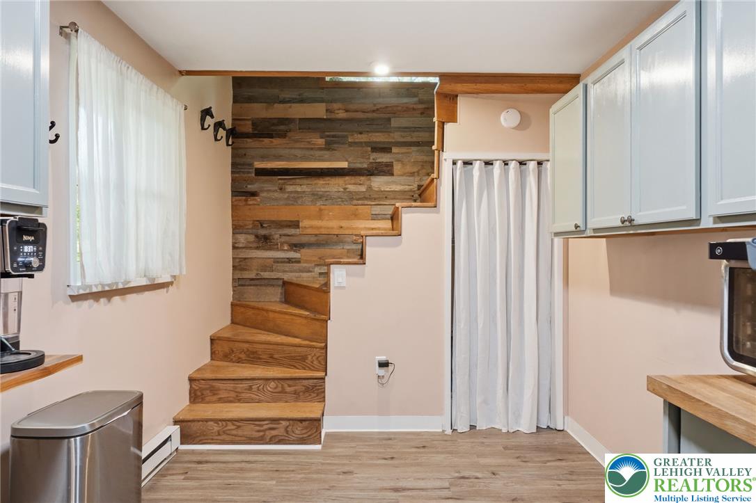 9033 Loop Road Slatington, PA 18080 - Photo 27 of 53 Custom wood paneling complements the warm wooden staircase leading to upper levels.