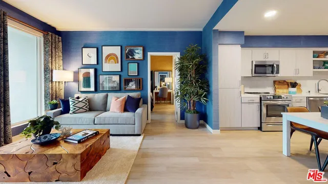 a living room with furniture and a kitchen view
