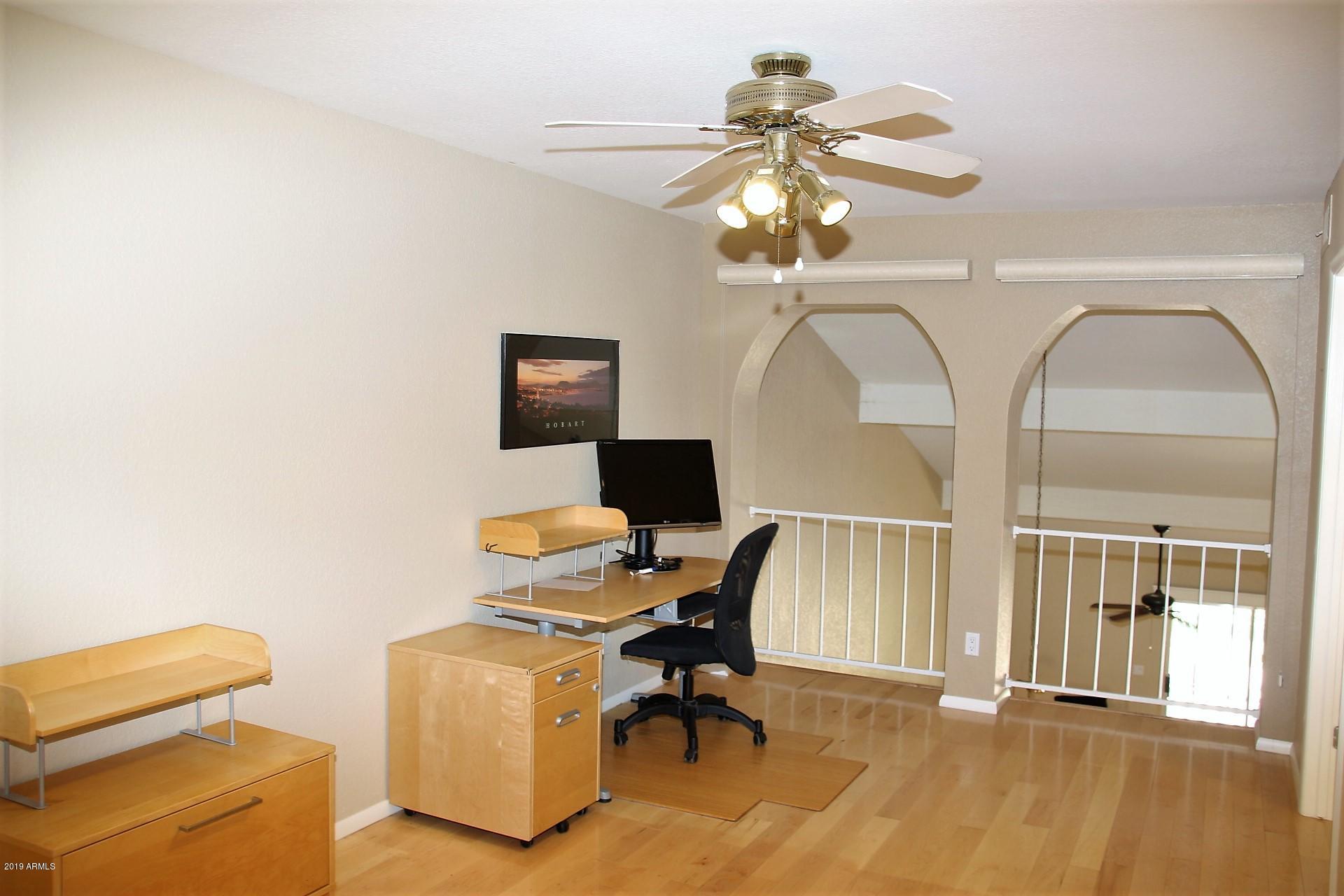 11615 North 40th Way Phoenix, AZ 85028 - Photo 11 of 33 a view of a workspace with furniture and a chandelier