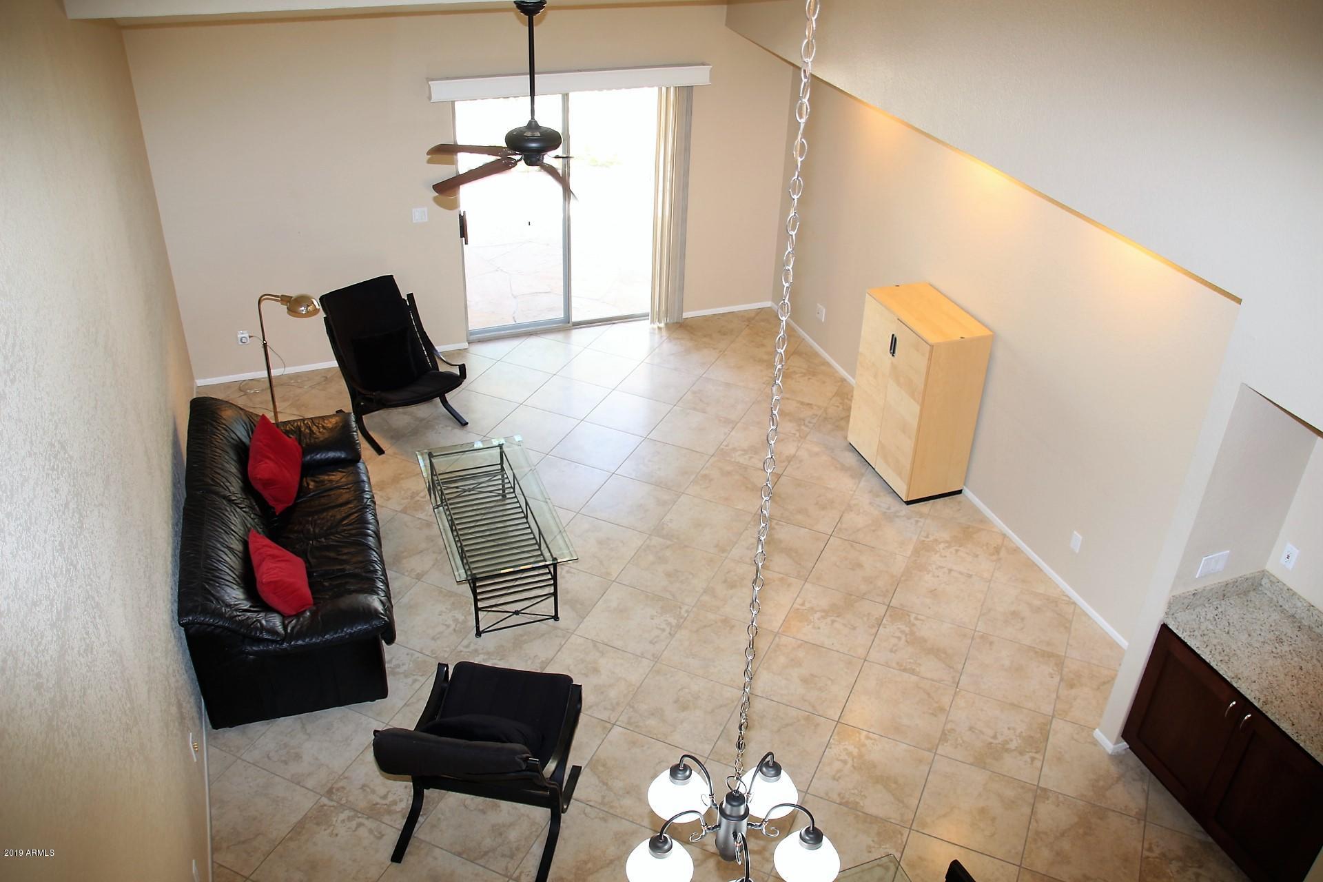 11615 North 40th Way Phoenix, AZ 85028 - Photo 17 of 33 a living room with furniture and a window
