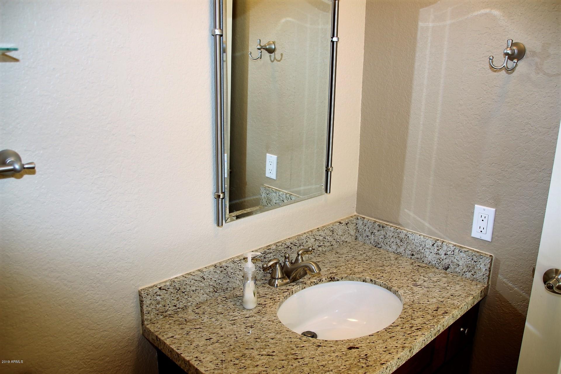 11615 North 40th Way Phoenix, AZ 85028 - Photo 25 of 33 a bathroom with a granite countertop sink and a mirror