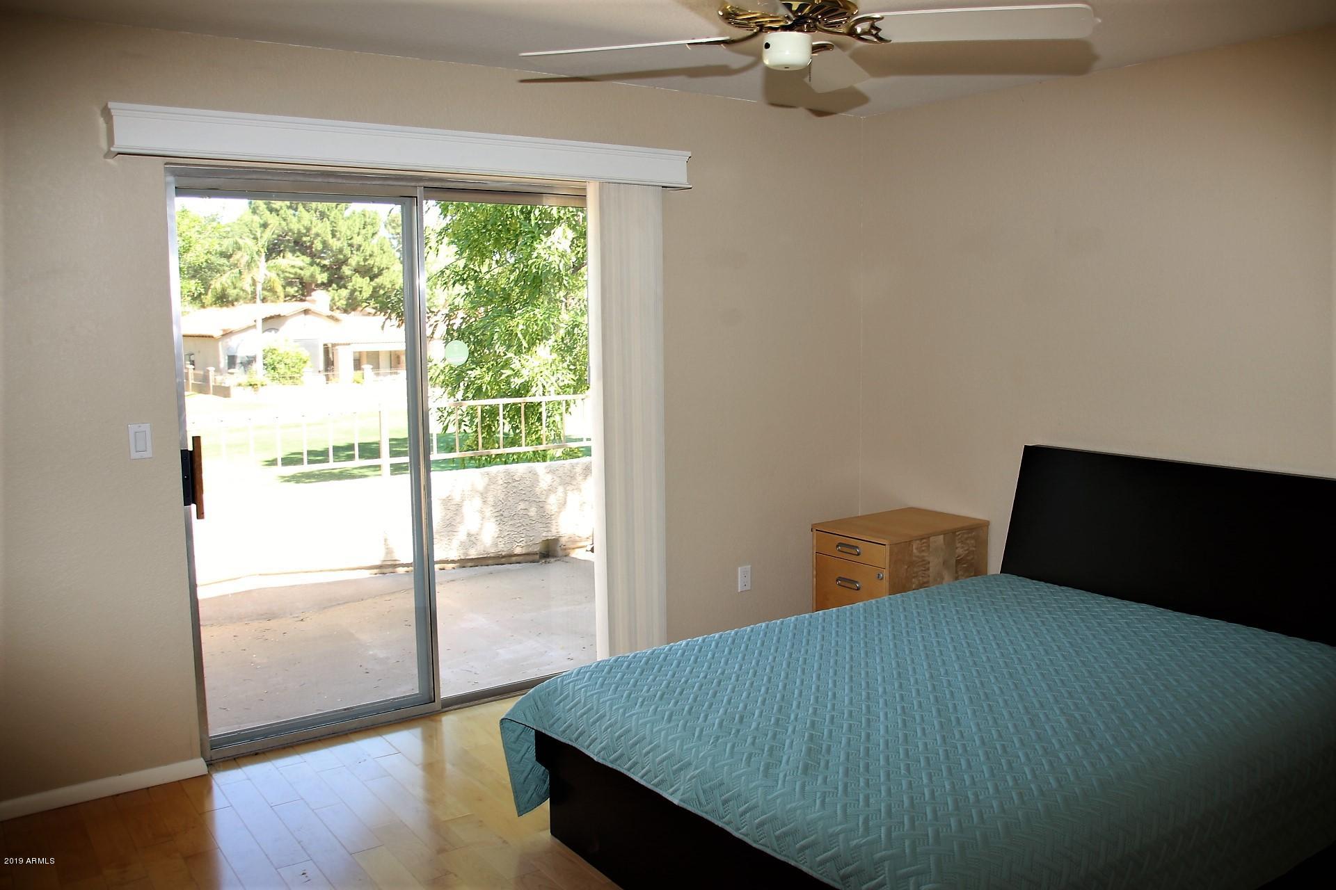 11615 North 40th Way Phoenix, AZ 85028 - Photo 5 of 33 a bedroom with wooden floor