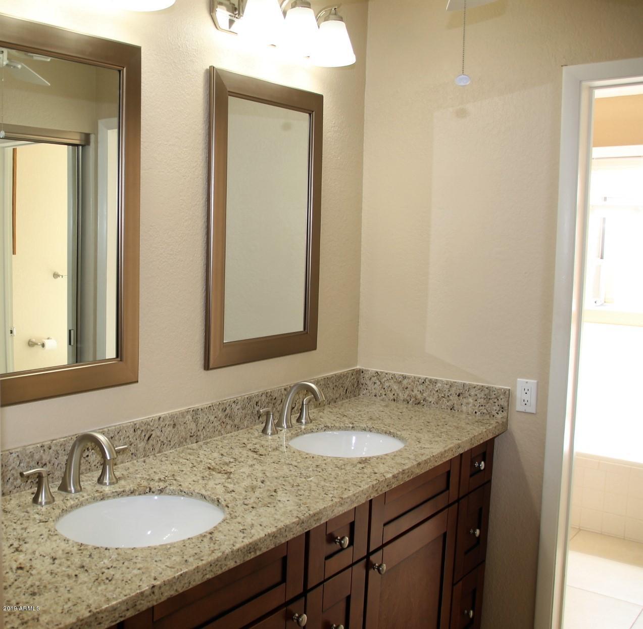 11615 North 40th Way Phoenix, AZ 85028 - Photo 6 of 33 a bathroom with a granite countertop sink and a mirror