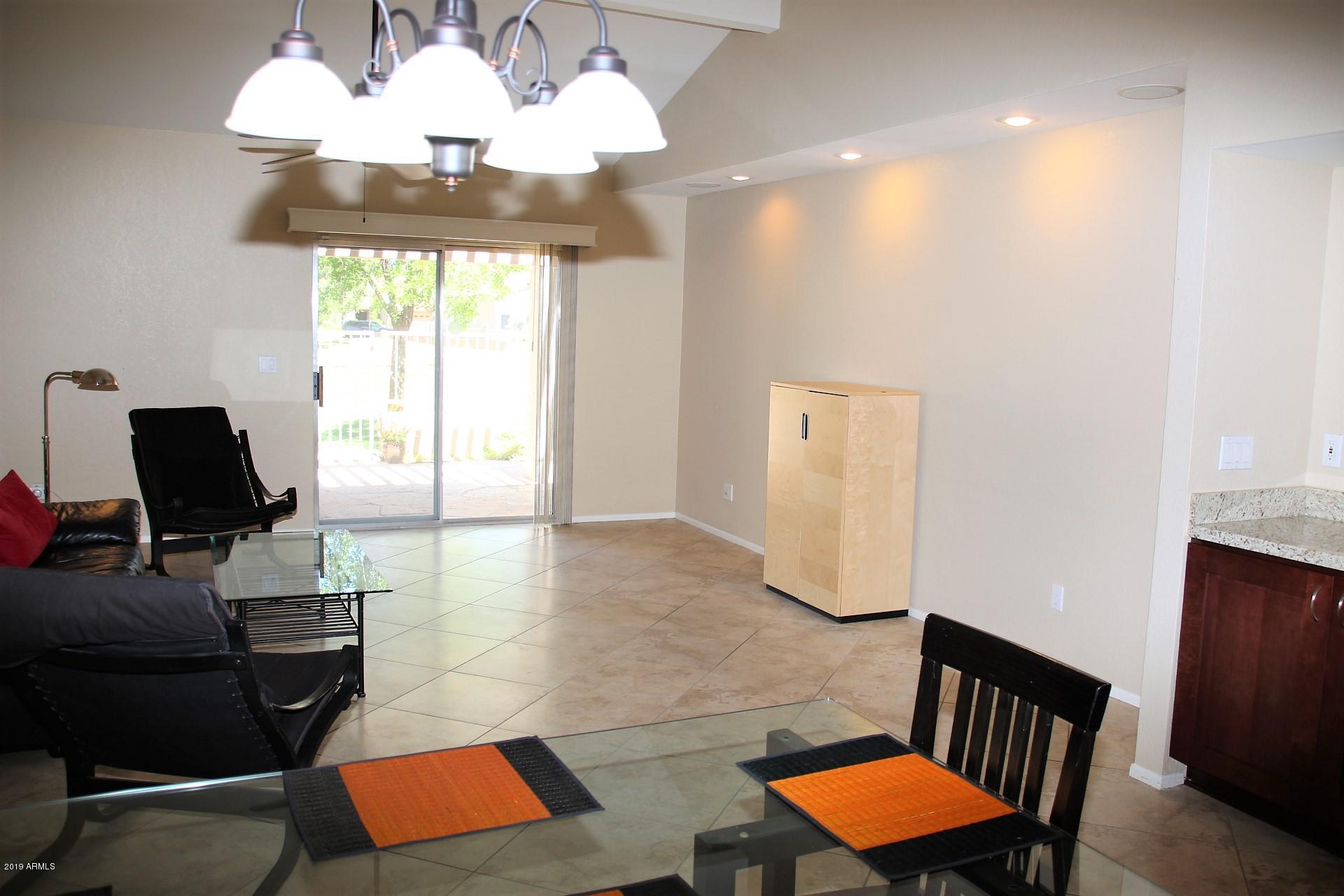 11615 North 40th Way Phoenix, AZ 85028 - Photo 8 of 33 a view of a workspace with furniture and a window