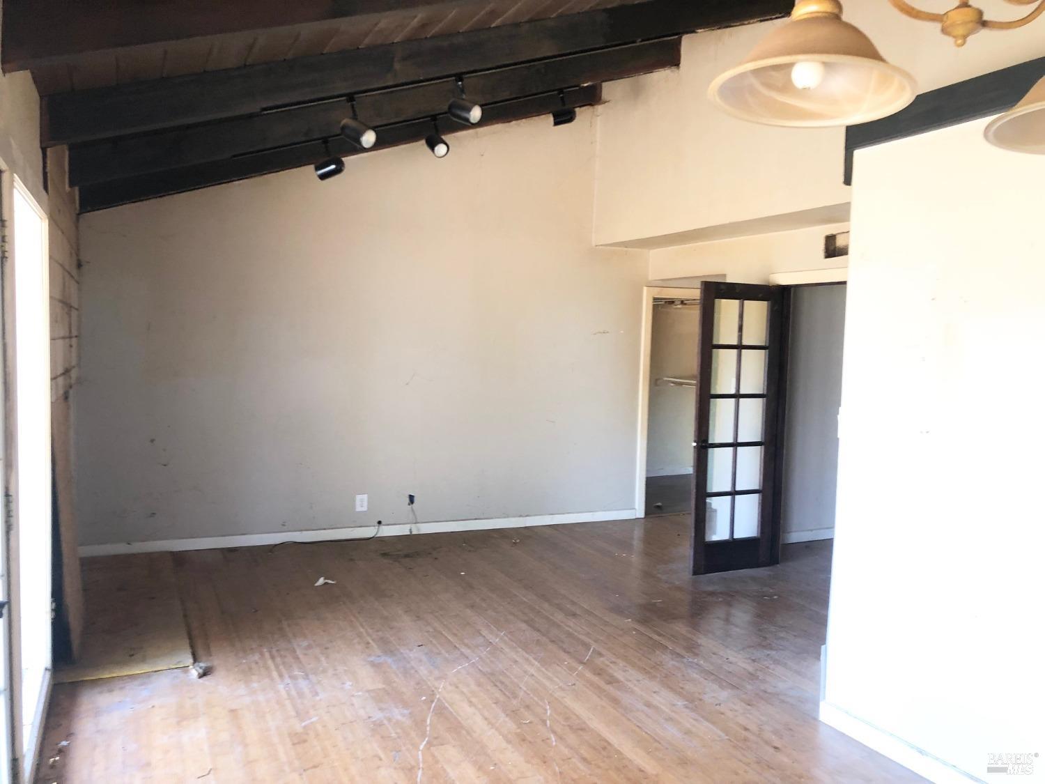 306 Marin Avenue Mill Valley, CA 94941 - Photo 19 of 26 an empty room with wooden floor and windows