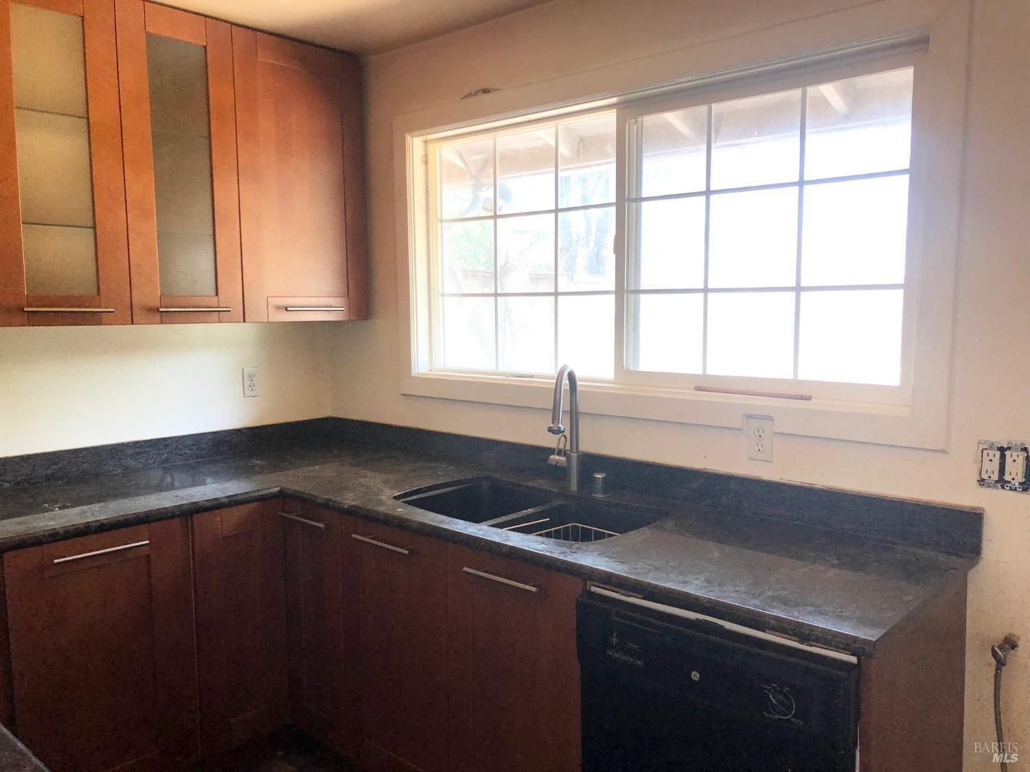 306 Marin Avenue Mill Valley, CA 94941 - Photo 4 of 26 a kitchen with granite countertop a sink and a window