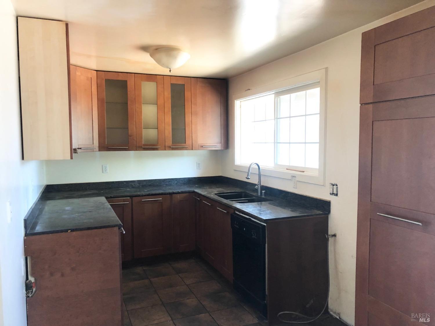 306 Marin Avenue Mill Valley, CA 94941 - Photo 5 of 26 a kitchen with a sink cabinets and window