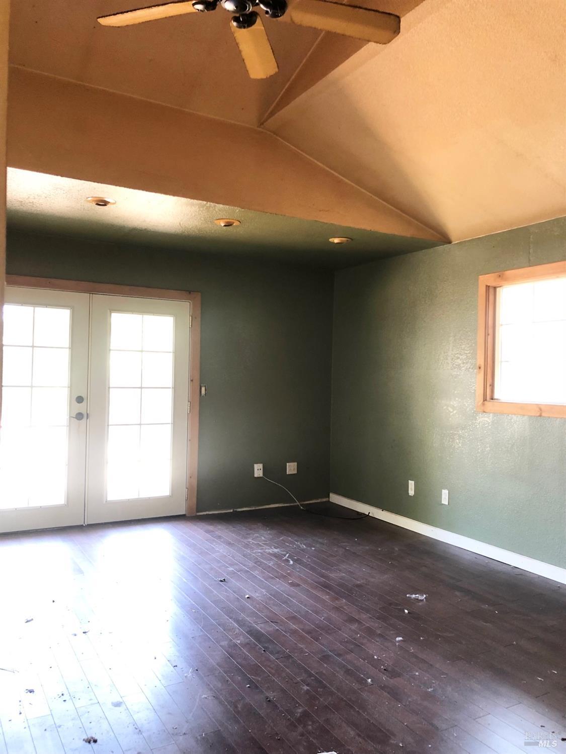 306 Marin Avenue Mill Valley, CA 94941 - Photo 9 of 26 an empty room with wooden floor and windows