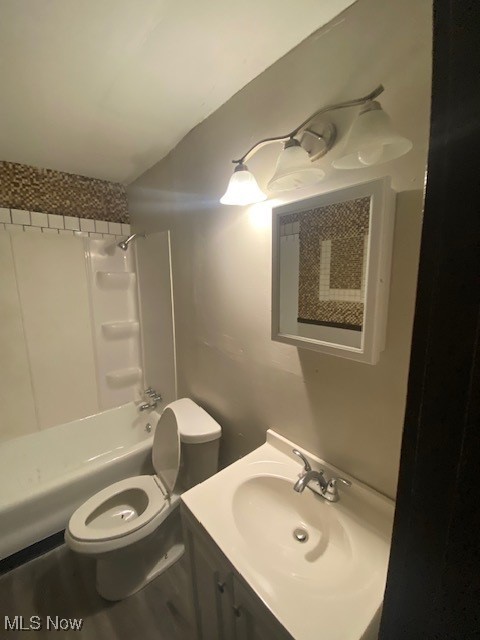 1843 Reyburn Road Cleveland, OH 44112 - Photo 15 of 39 Full bathroom featuring shower / bathing tub combination, vanity, toilet, and wood-type flooring