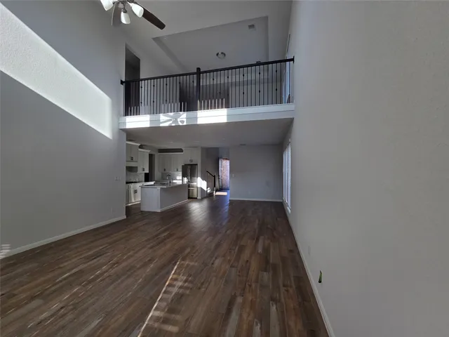 a kitchen with a sink and wooden floor