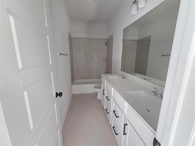 a bathroom with a tub a sink and mirrors