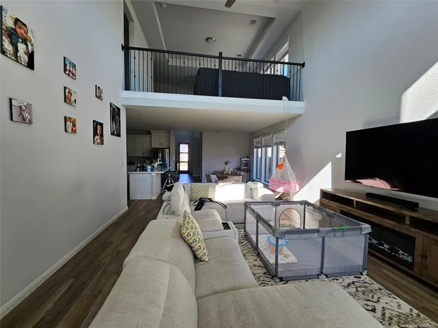 a living room with furniture and large windows