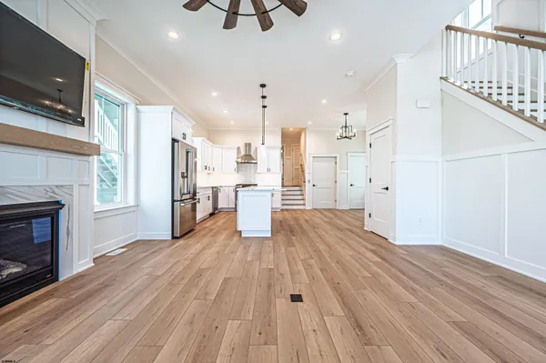 a kitchen with stainless steel appliances granite countertop a sink a stove and a refrigerator