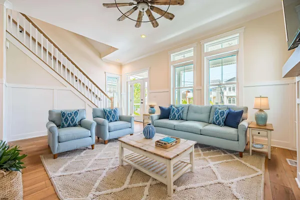 a kitchen with stainless steel appliances a dining table chairs and wooden floor