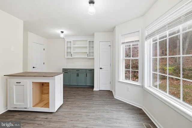 a kitchen with granite countertop a stove a sink and a refrigerator