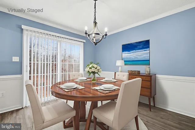 a view of a livingroom with wooden floor and a large window