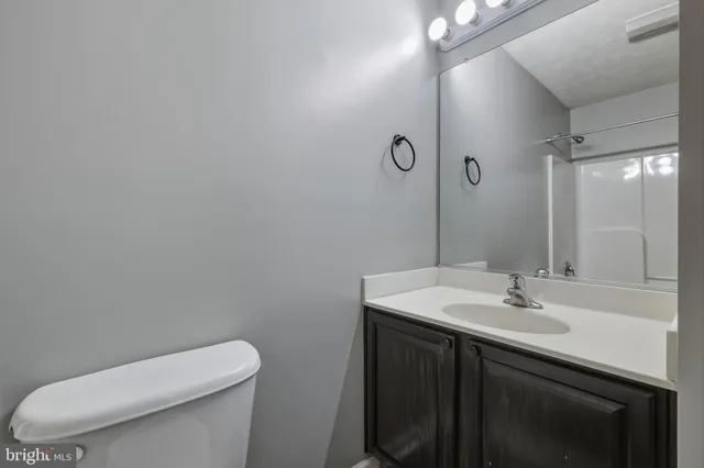 a white toilet sitting next to a bath tub
