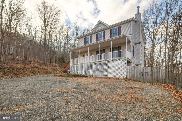 a view of a mountain range in a field