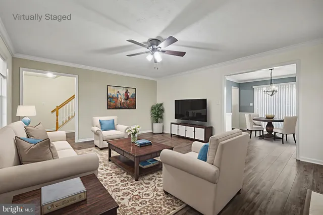 a view of an empty room with wooden floor and a ceiling fan