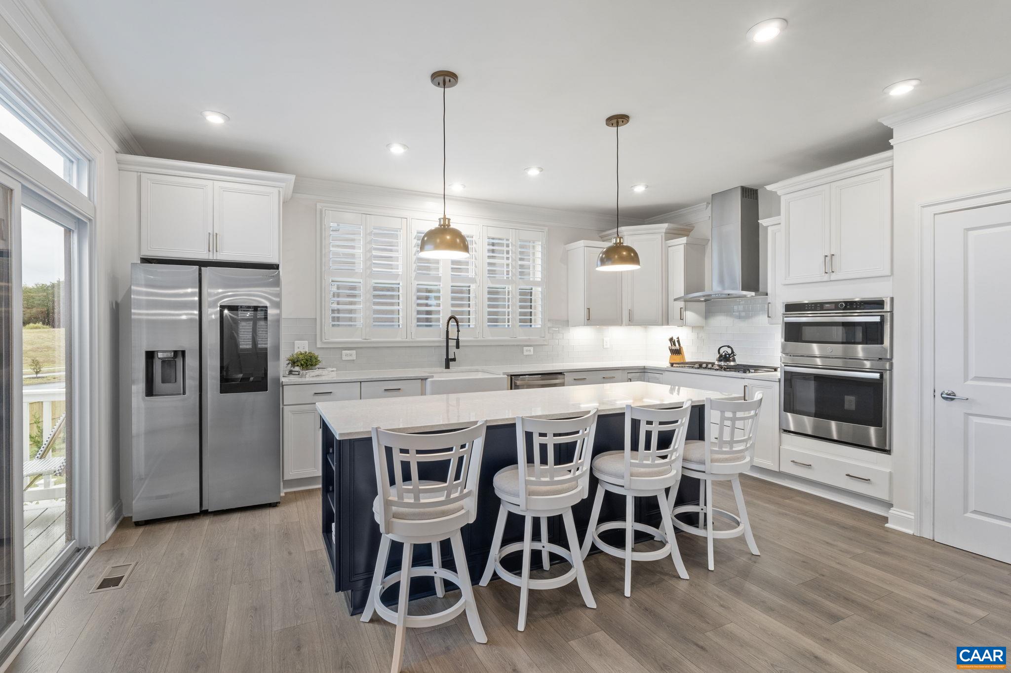 3712 Thicket Run Place Charlottesville, VA 22911 - Photo 17 of 73 a kitchen with stainless steel appliances granite countertop a kitchen island a stove a table and chairs