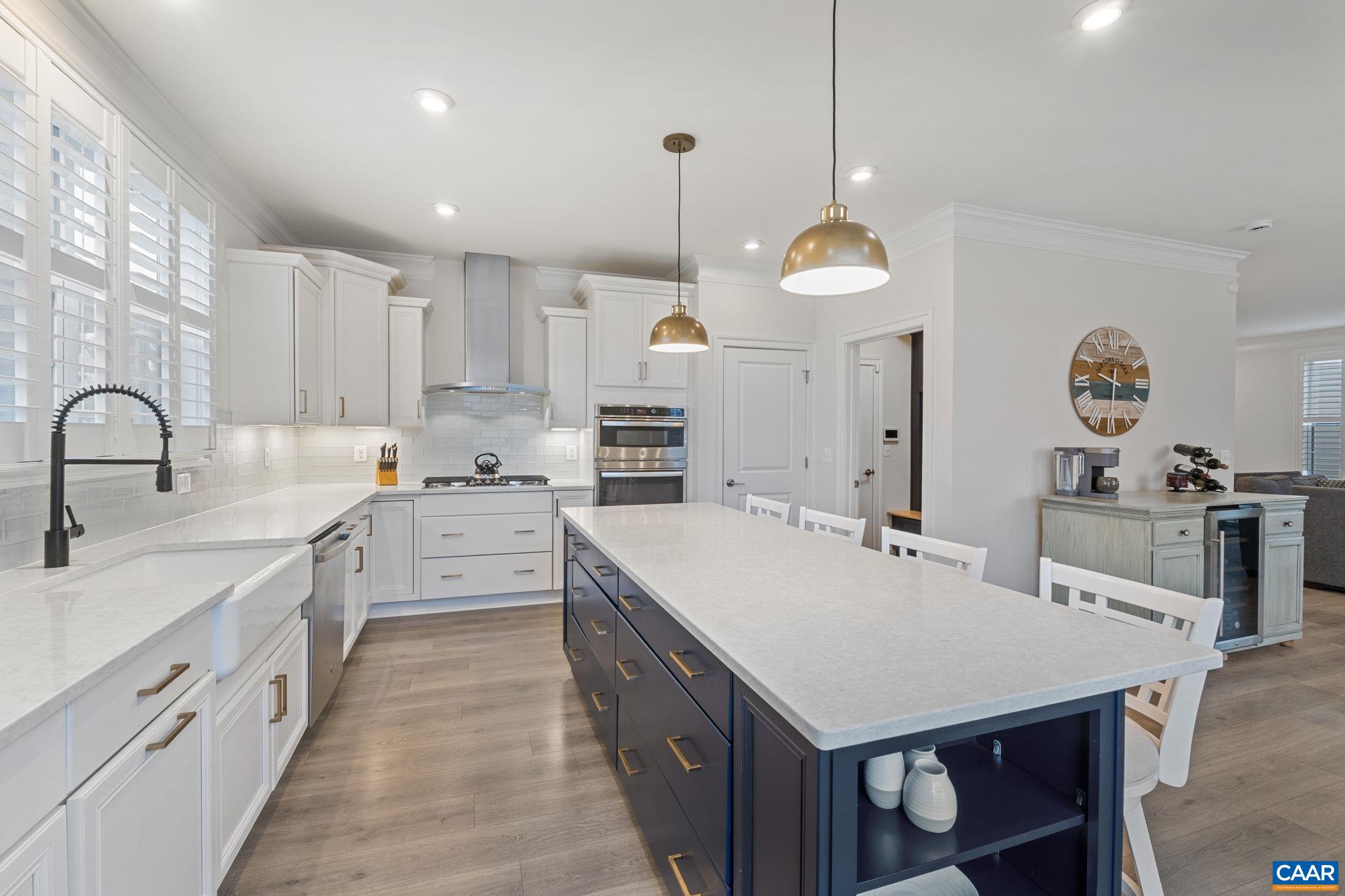 3712 Thicket Run Place Charlottesville, VA 22911 - Photo 21 of 73 a kitchen with a stove a sink a center island and cabinets