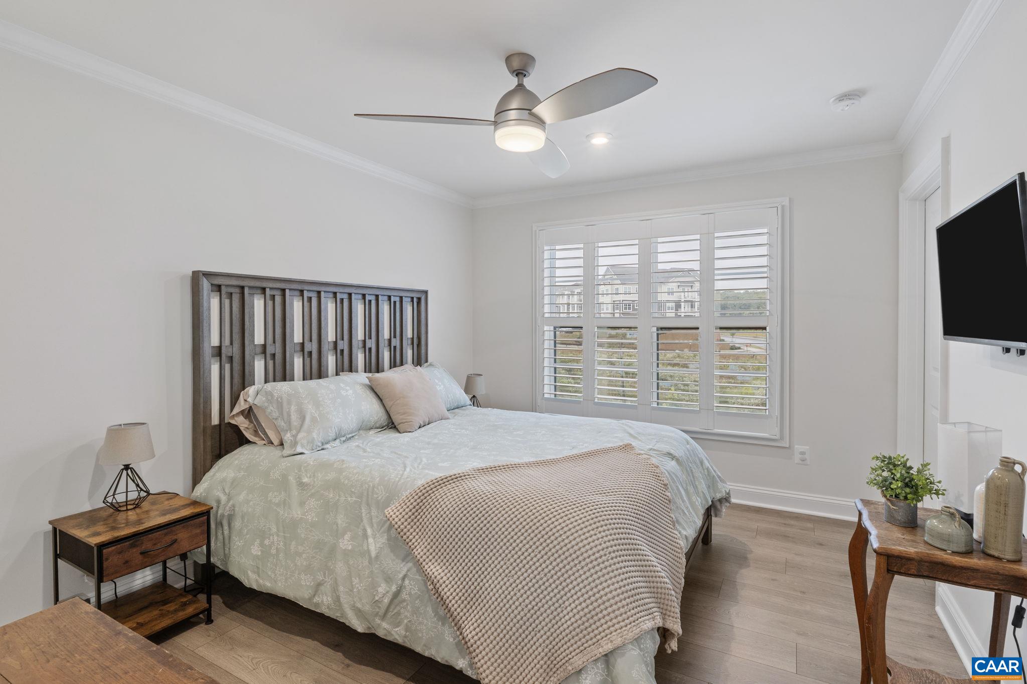 3712 Thicket Run Place Charlottesville, VA 22911 - Photo 39 of 73 a bedroom with a bed a window and a flat screen television