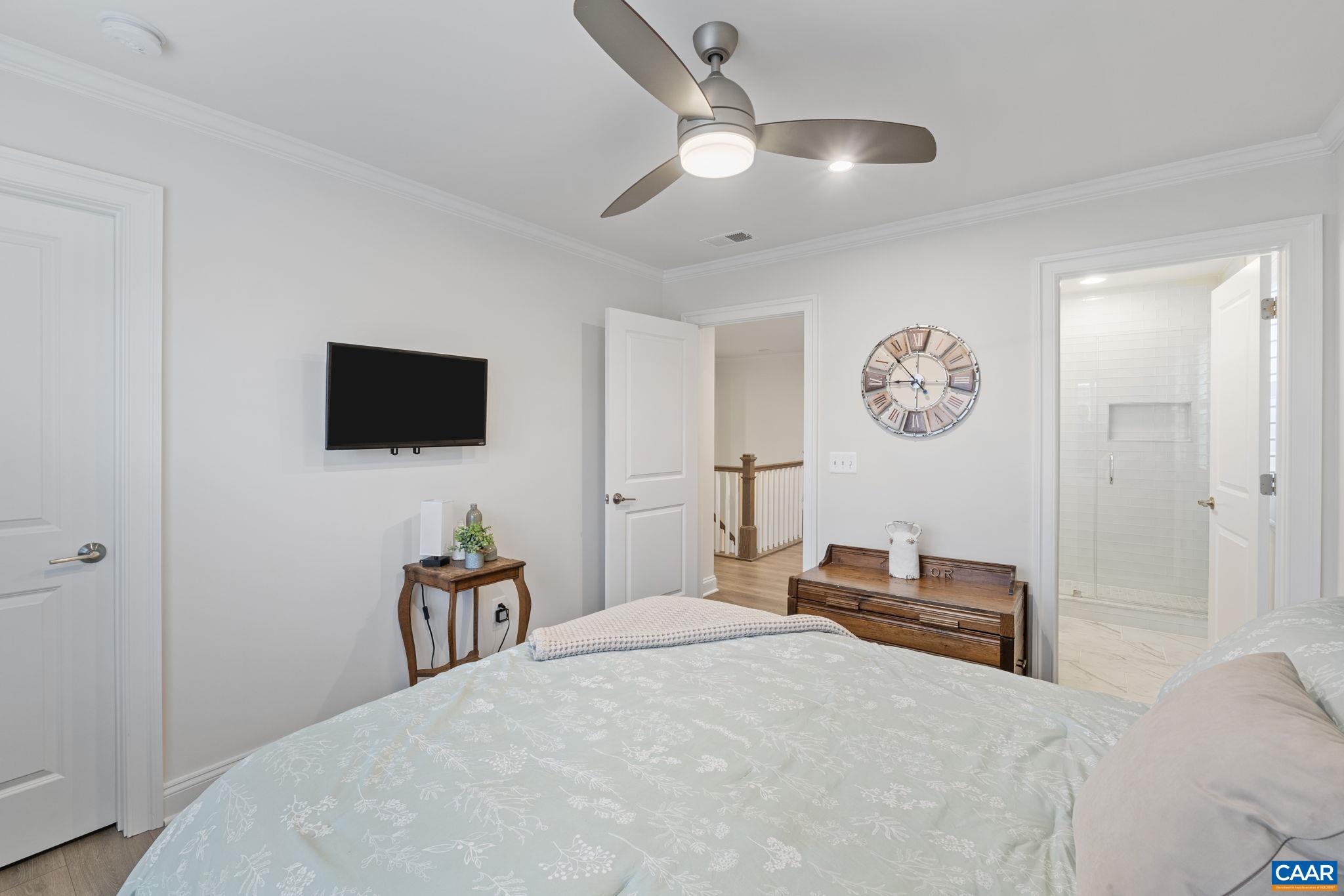 3712 Thicket Run Place Charlottesville, VA 22911 - Photo 40 of 73 a bedroom with a bed and a flat tv screen on wall