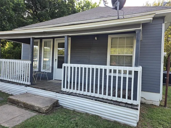 a side view of a house with a porch