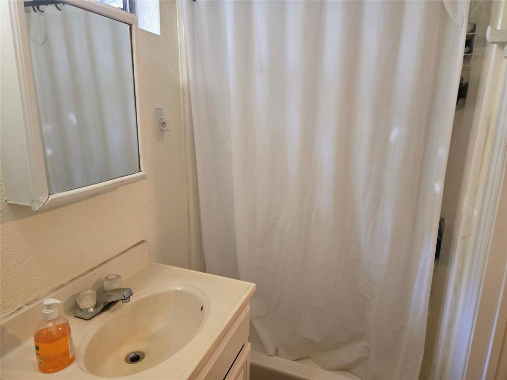 535 Hancock Street Gainesville, TX 76240 - Photo 16 of 22 a bathroom with a sink and a tub
