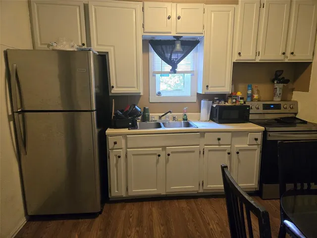 a white refrigerator freezer sitting inside of a kitchen