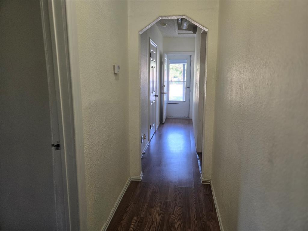 535 Hancock Street Gainesville, TX 76240 - Photo 7 of 22 a view of a hallway with wooden floor