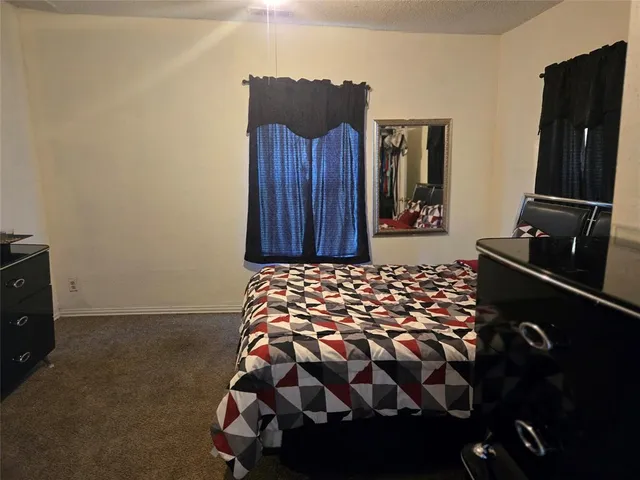a bedroom with a bed and a flat tv screen