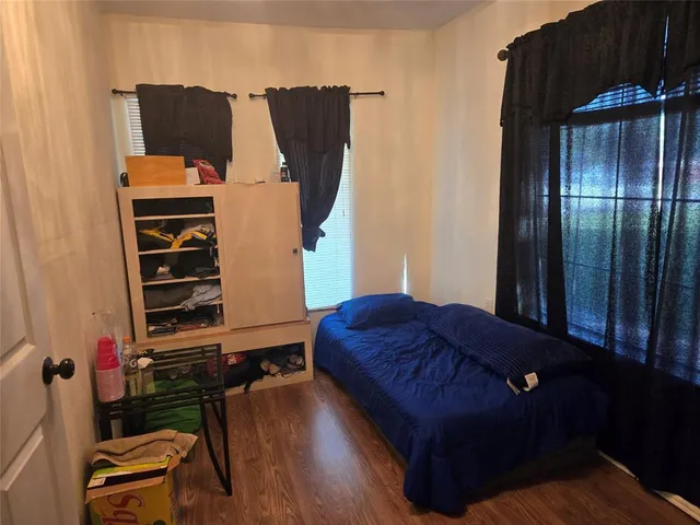 a bedroom with a bed and a television