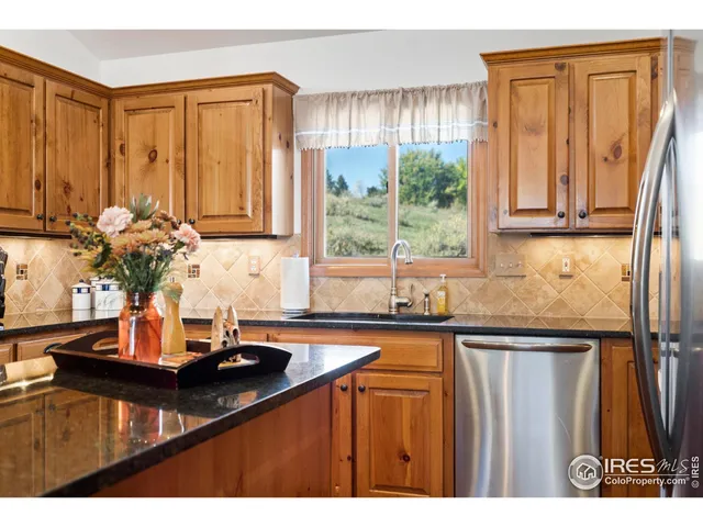 a bathroom with a granite countertop sink toilet a mirror and shower