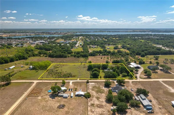 an aerial view of a residential houses with outdoor space